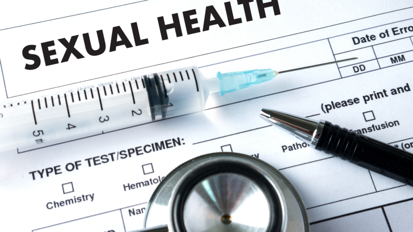 Sexual health form with a syringe, stethoscope, and pen on top